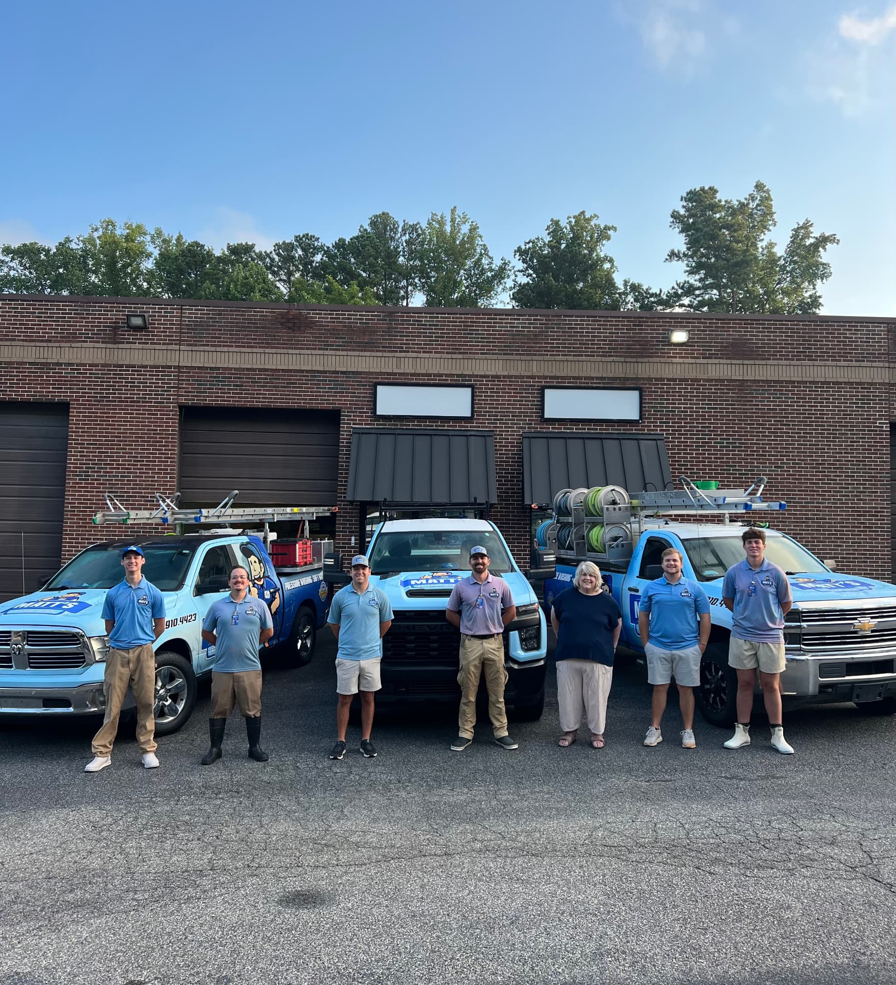 The Matt's Exterior Washing team in front of their branded trucks