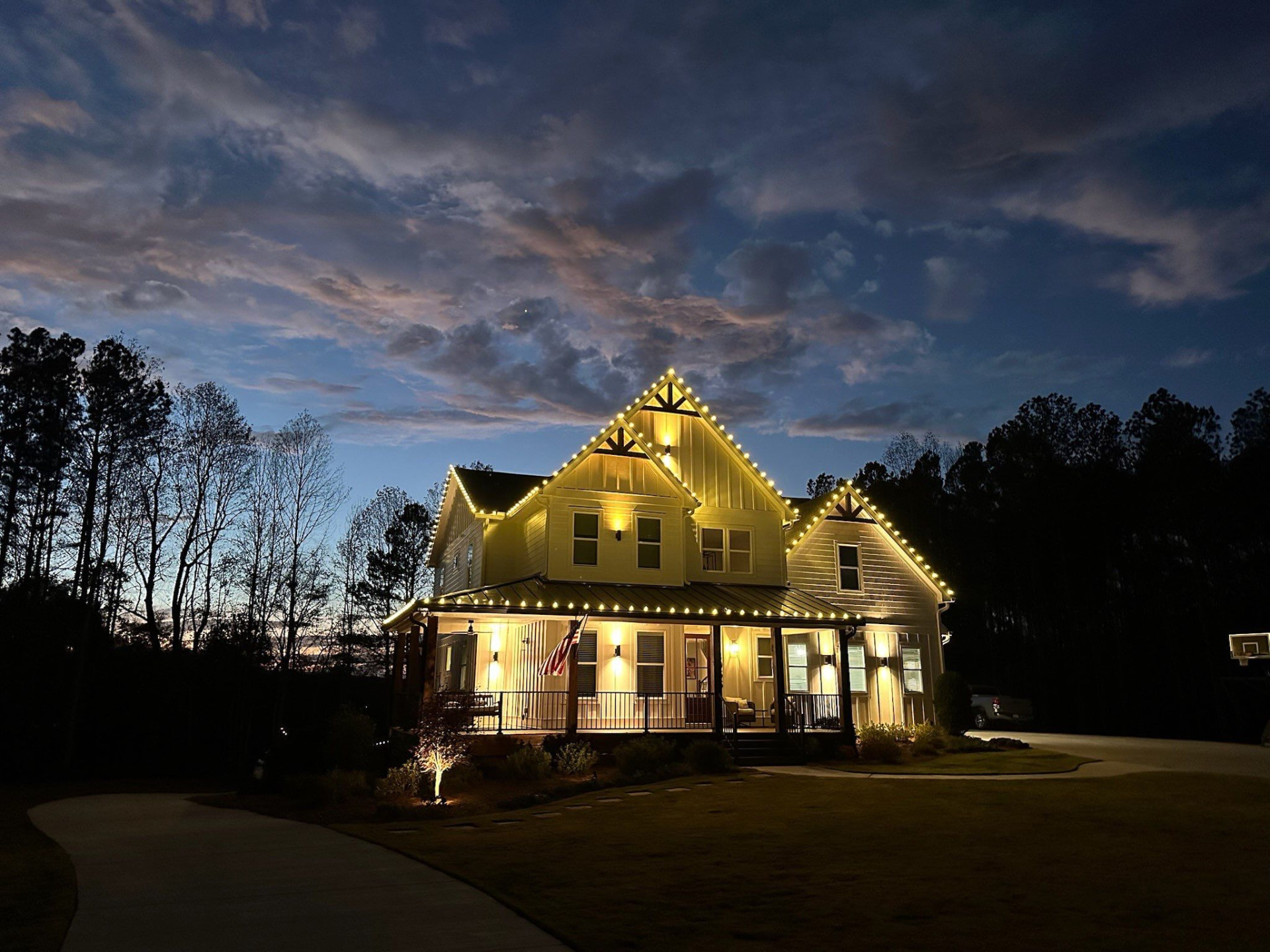 Golden roofline Christmas lights at dusk